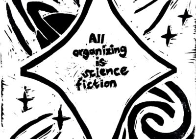 Black and white linocut print with the following quote from adrienne maree brown in the center of a star: “All organizing is science fiction.” The background contains outer space motifs, including a planet, a galaxy, and shooting stars.